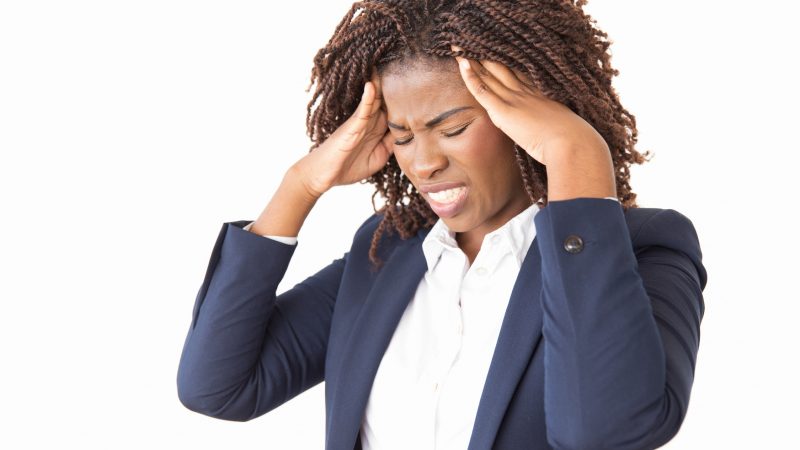 Stressed female holding temples